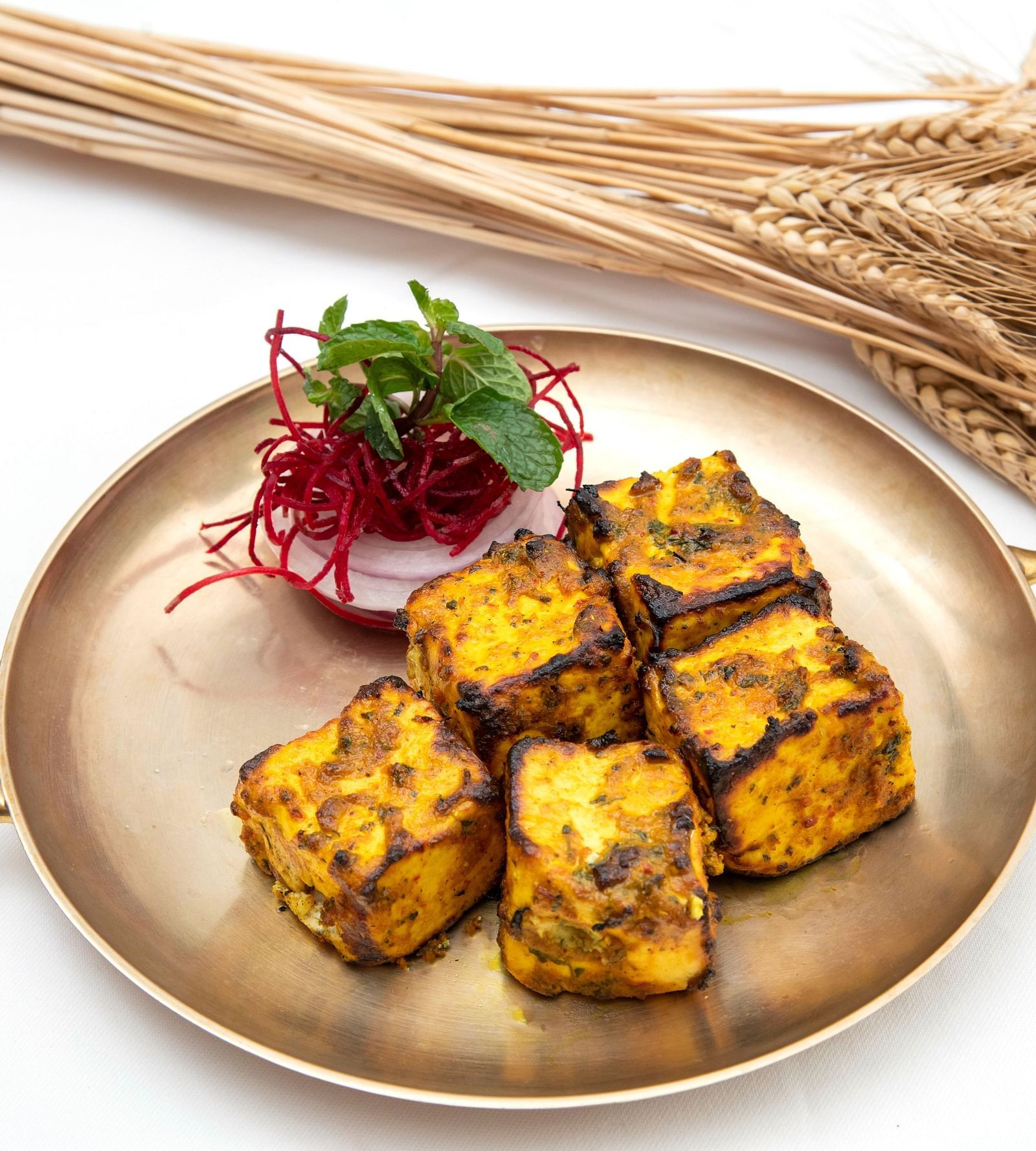 image of a plate featuring panner tikka served with some salad at the dhaba - The Claridges New Delhi