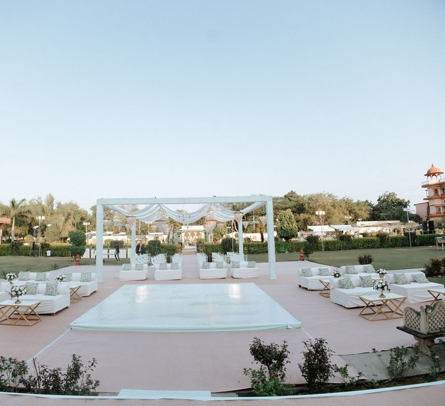 Wide shot of poolside wedding venue setup with floral mandap at Umaid Palace.