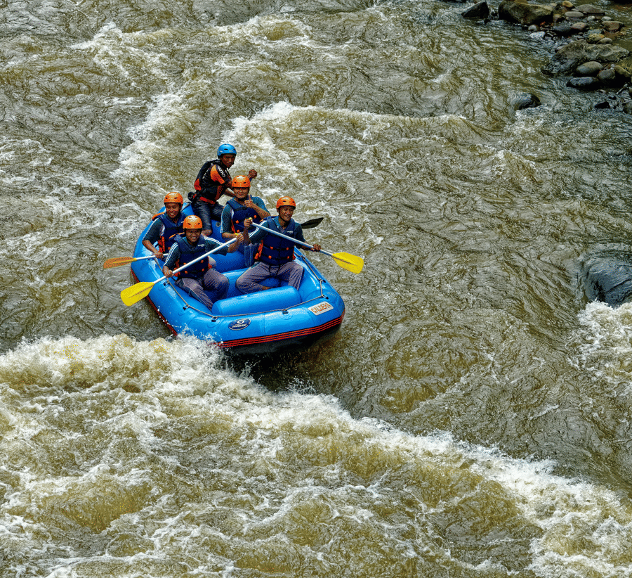 Aerial view of river rafting on a flowing river, showcasing the excitement of adventure amidst the natural landscape.