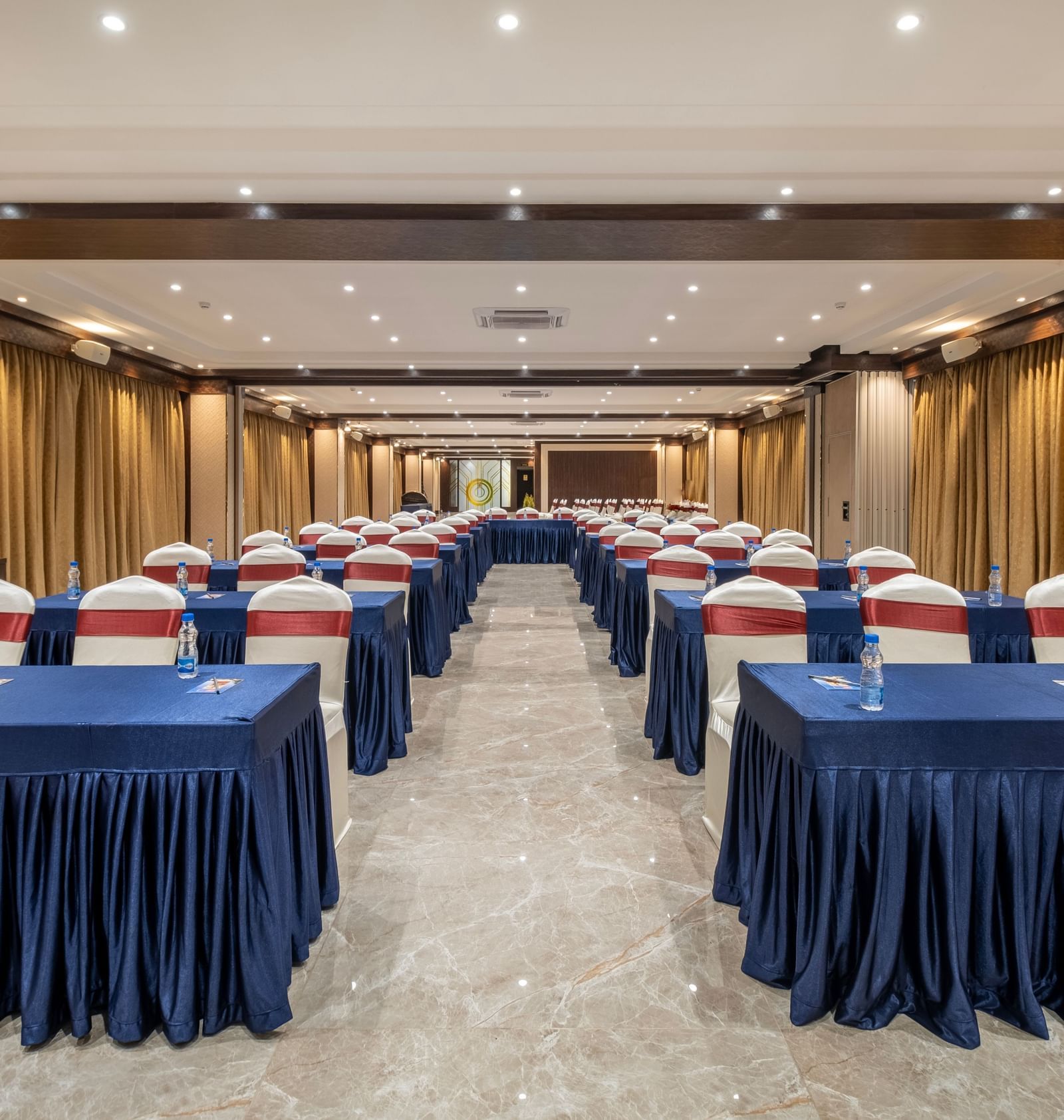 Spacious hall at Monday Hotels Amalapuram Heights with classroom seating arrangement.