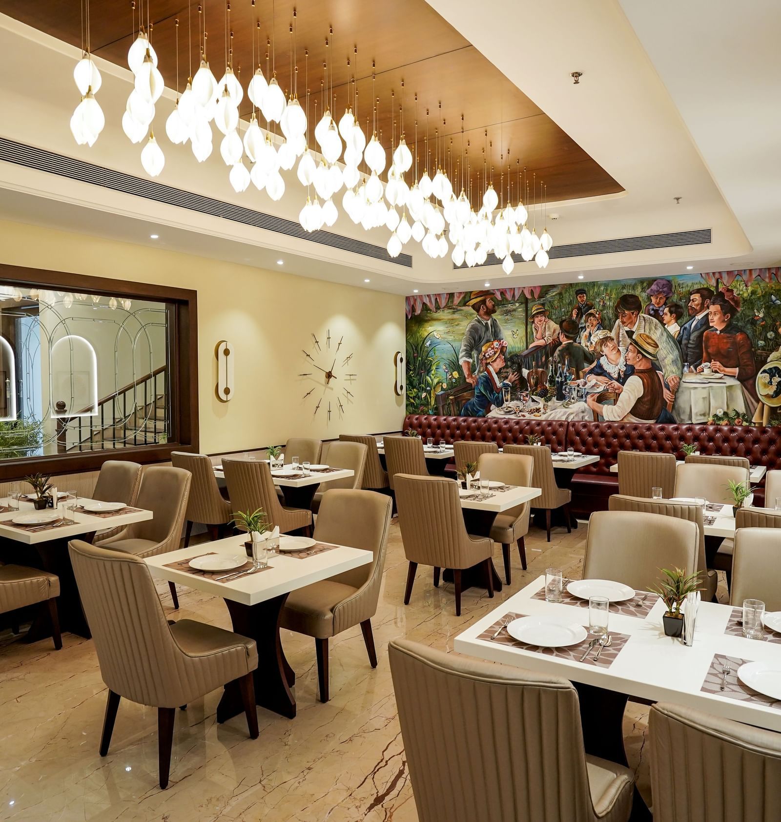 A wide angle shot of the Mosaic restaurant featuring a brightly lit dining area with modern interiors and well arranged tables at M2 Square by Monday Premium.