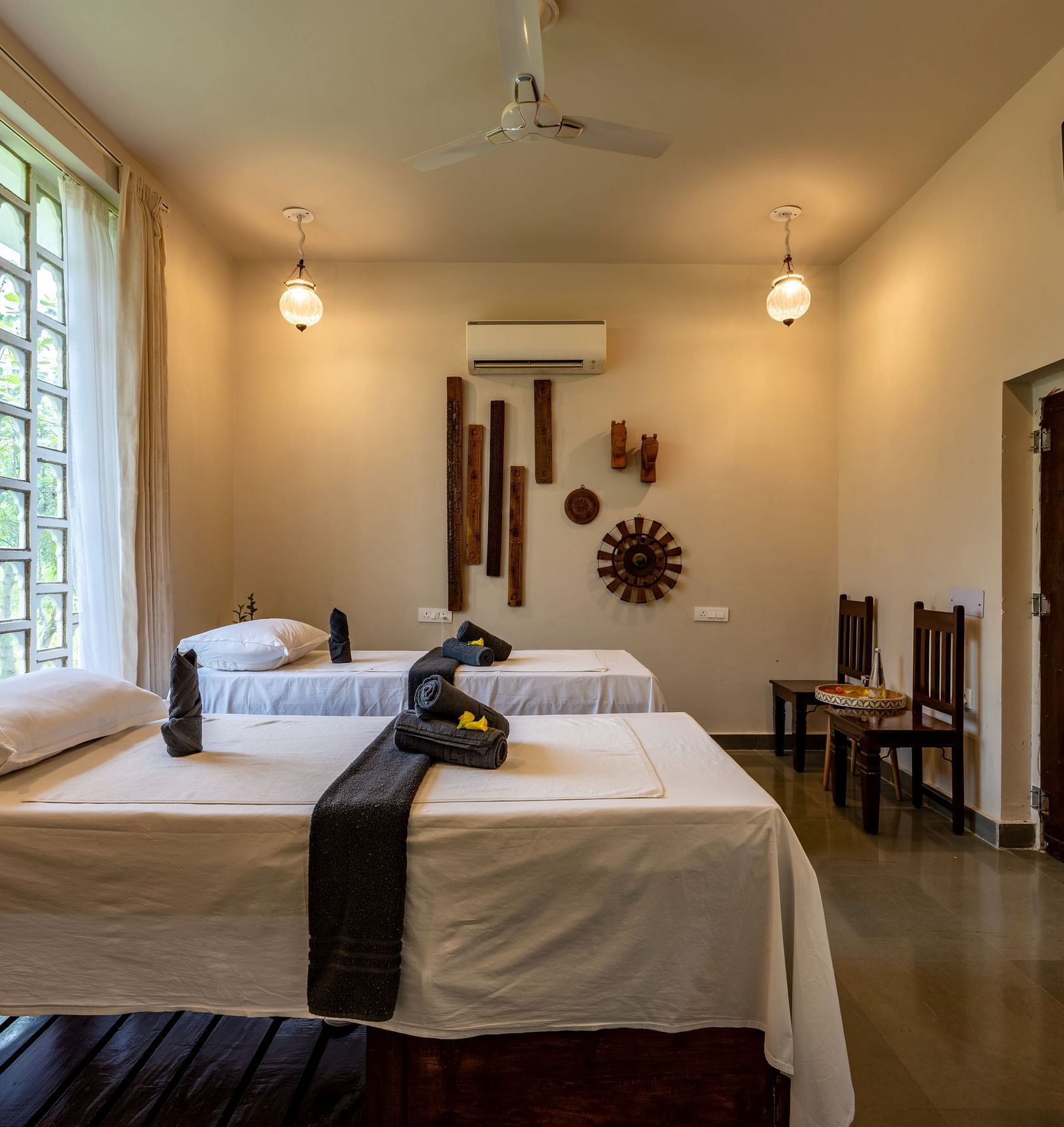 A side angle of the spa with ambient lighting and two beds - Utsav Camp