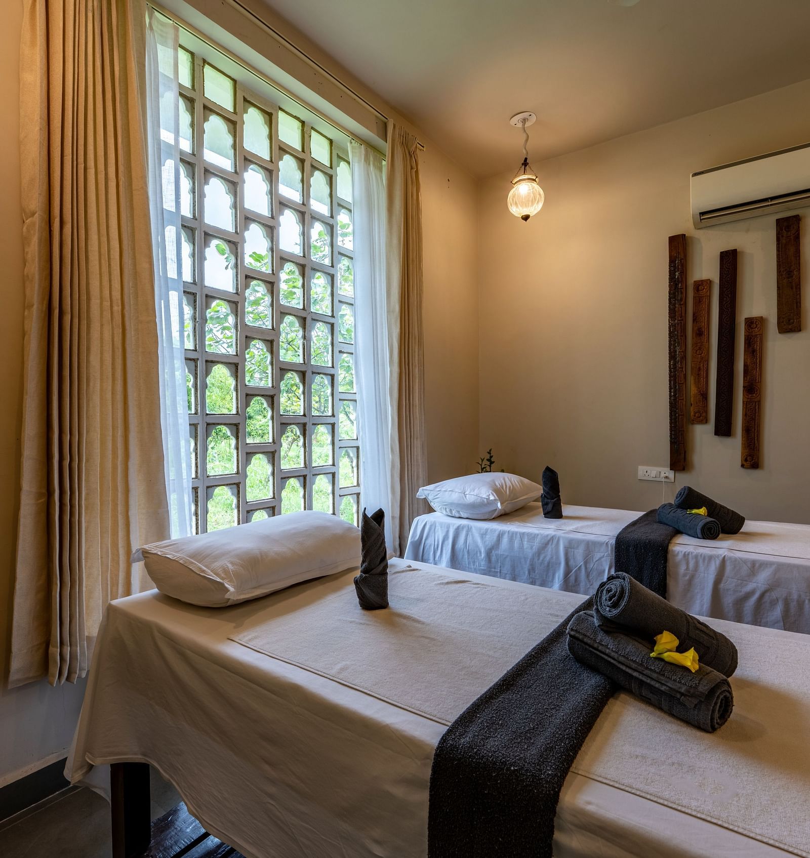 A close up shot of the bed with towels placed on them in our spa - Utsav Camp