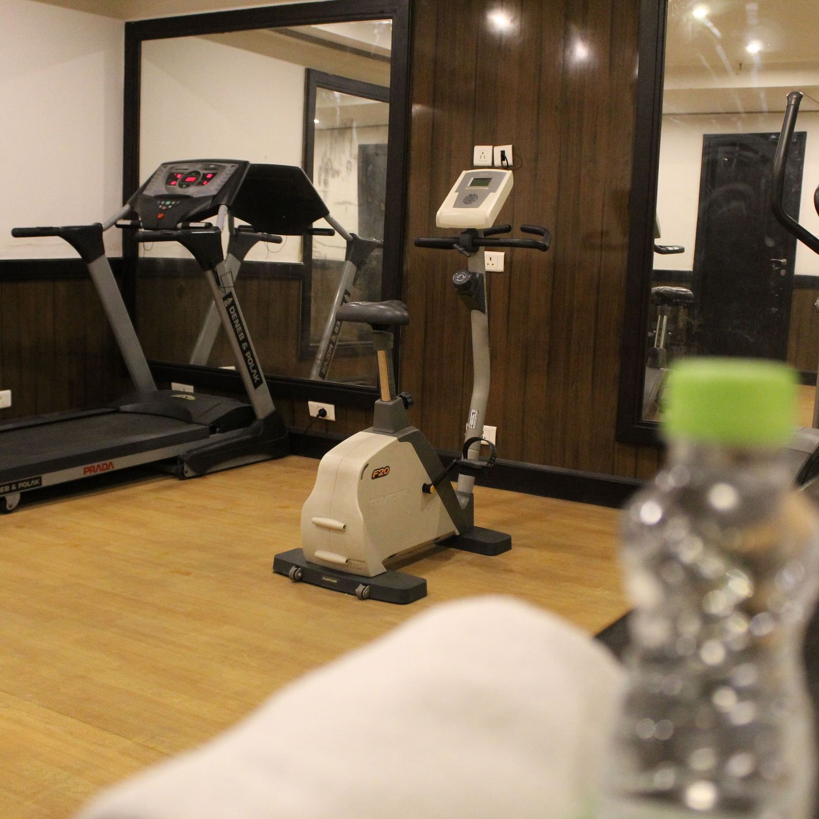 An image of a gym at Inde Hotel Vista Woods featuring treadmill , cardio machine, and other fitness quipment