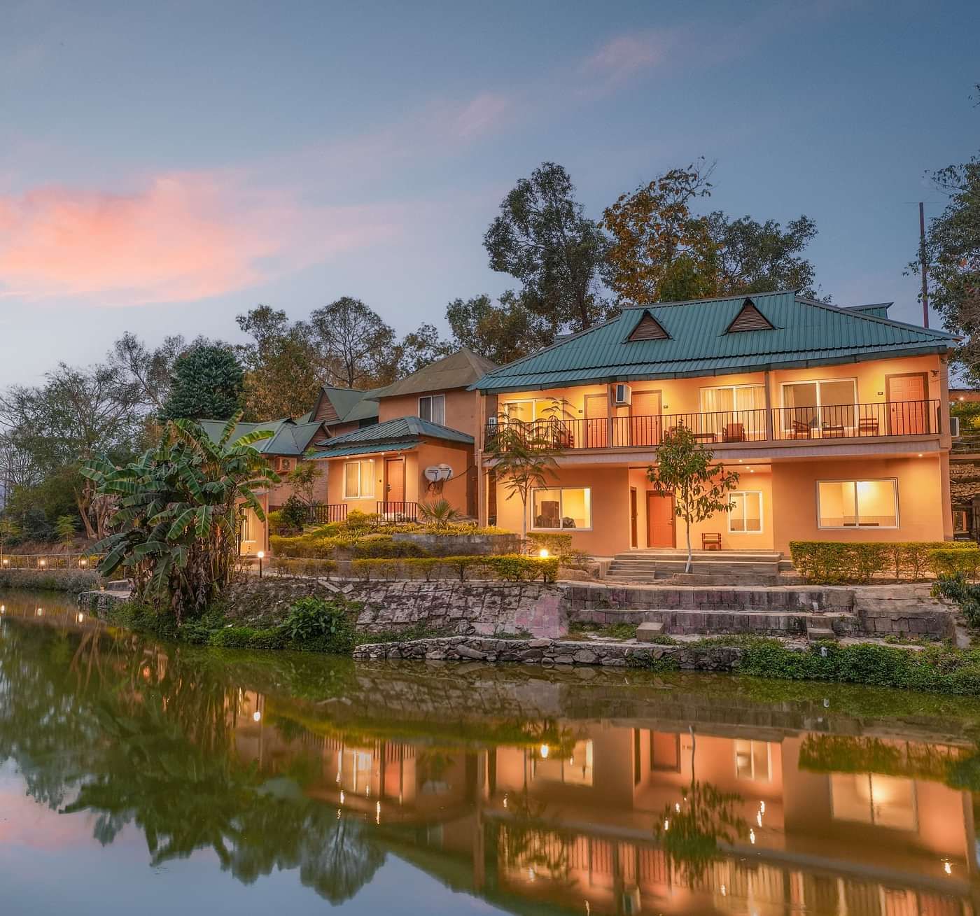 Facade view reflection on the lake at Summit Green Lake Tea Resort & Spa, Kaziranga