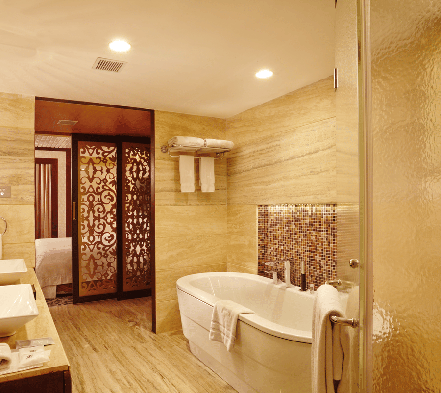 Bathroom of hablis suite with a bathtub and toiletries at Hablis Hotel, Chennai