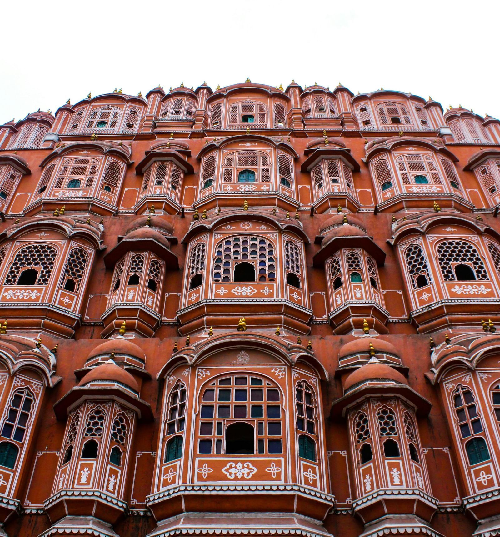 A multi-windowed palace against cloudy sky