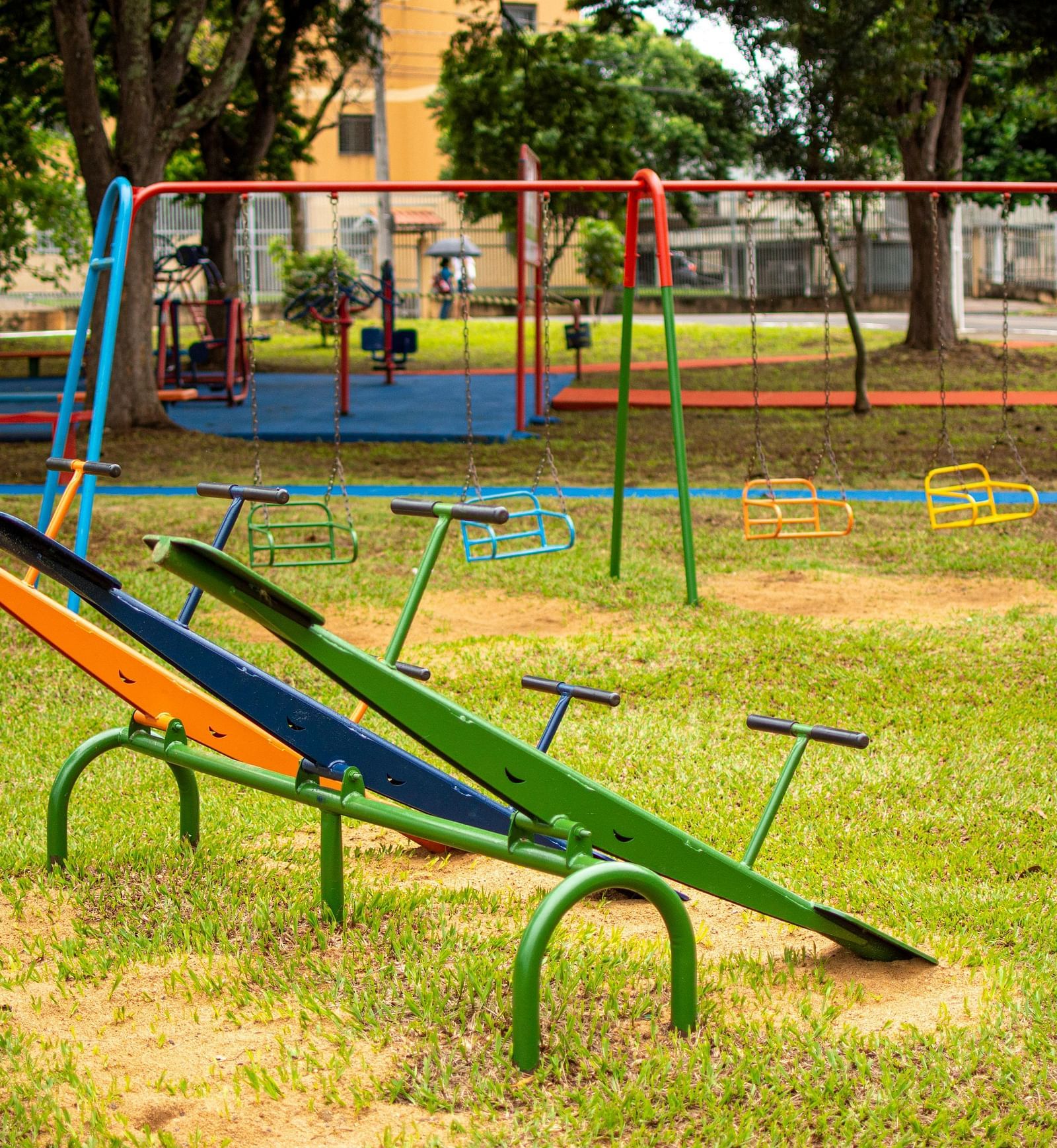 Playground with colourful seesaws and swings.