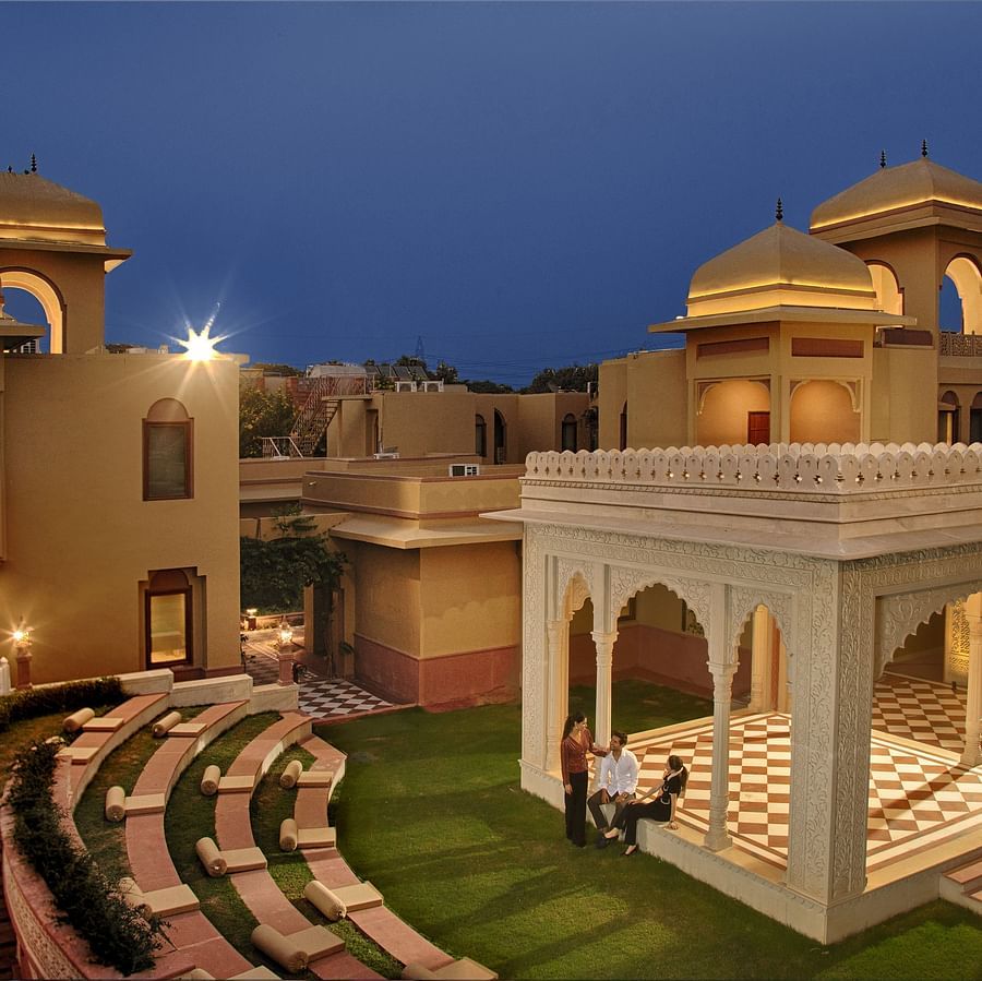  An open-air amphitheatre and traditional pavilion set amidst a serene courtyard at dusk -  Heritage Village Resorts & Spa, Manesar