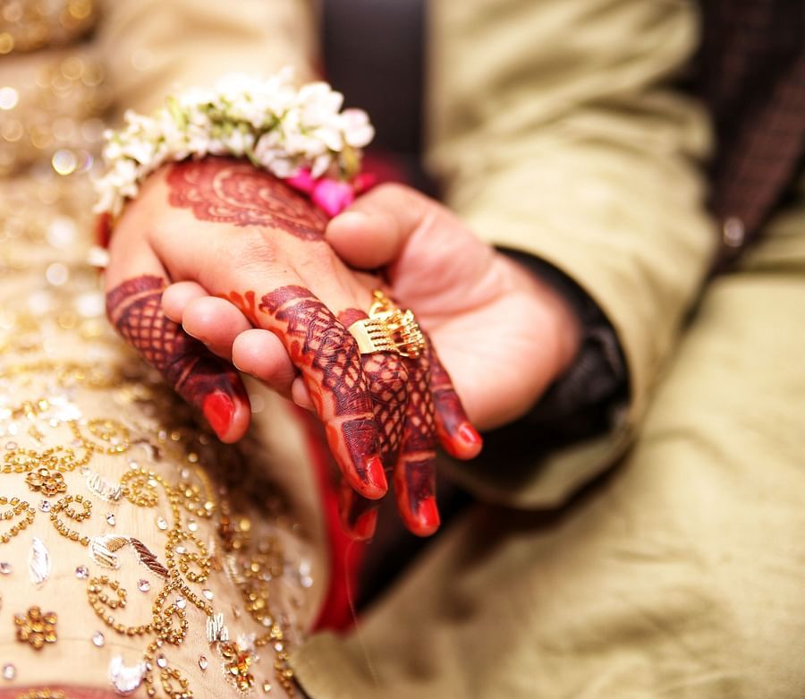 a husband and wife holding hands during a marriage ceremony
