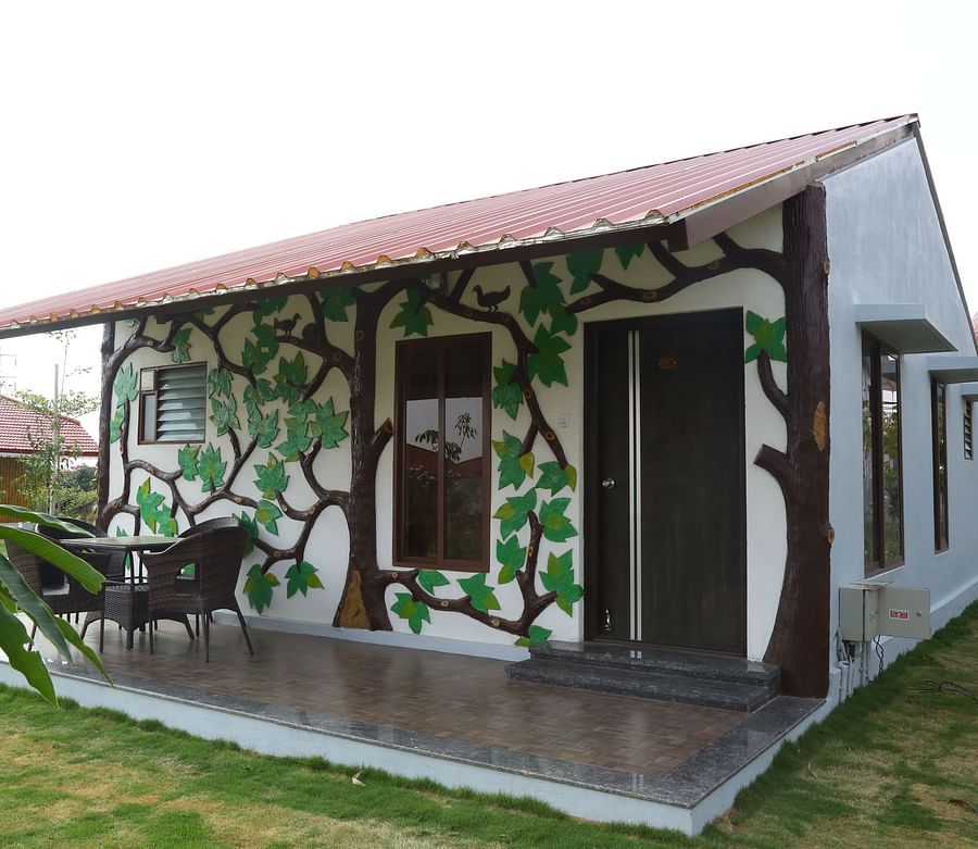 Exterior of the Themed Suite Villa with a porch and with a private lawn at GK Hill View Resort.