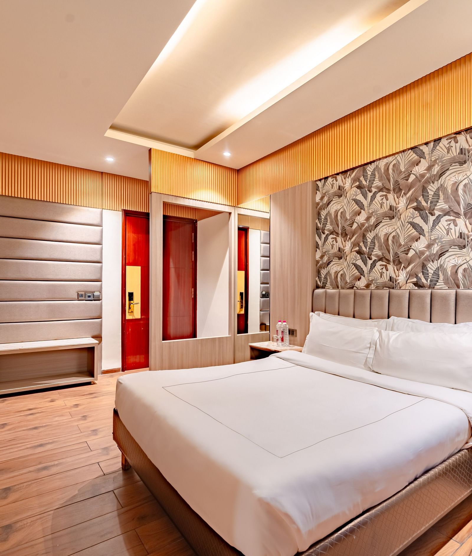 Family Room offers a spacious bed with a bedside table, window curtains, and a wall-mounted television at Crescent Spa & Resort, Indore