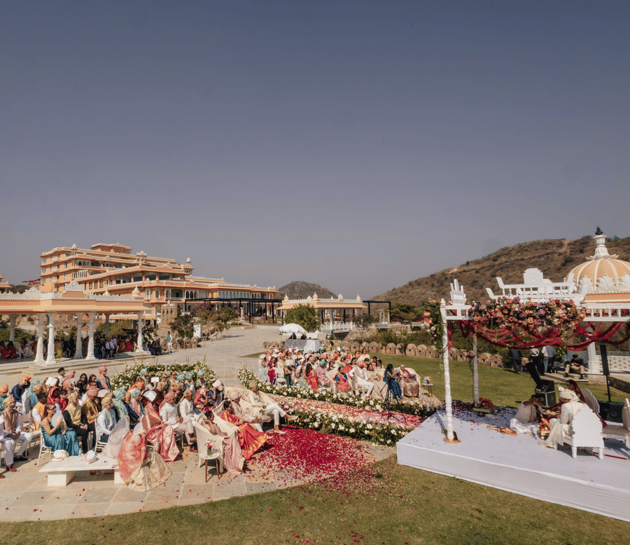 Crowd gathered in a lawn at the Fateh Vilas, Udaipur to watch the wedding rituals taking place between the bride and groom under a decorated canopy.