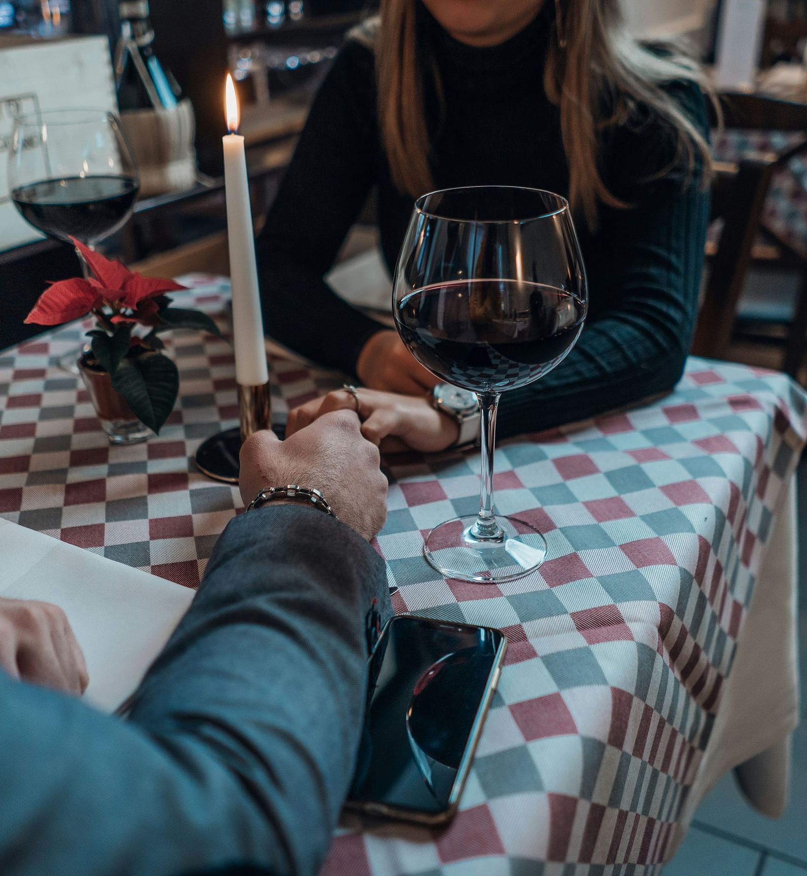 A  couple having a meal on a table holding hands |  Mango Hill Central, Chennai