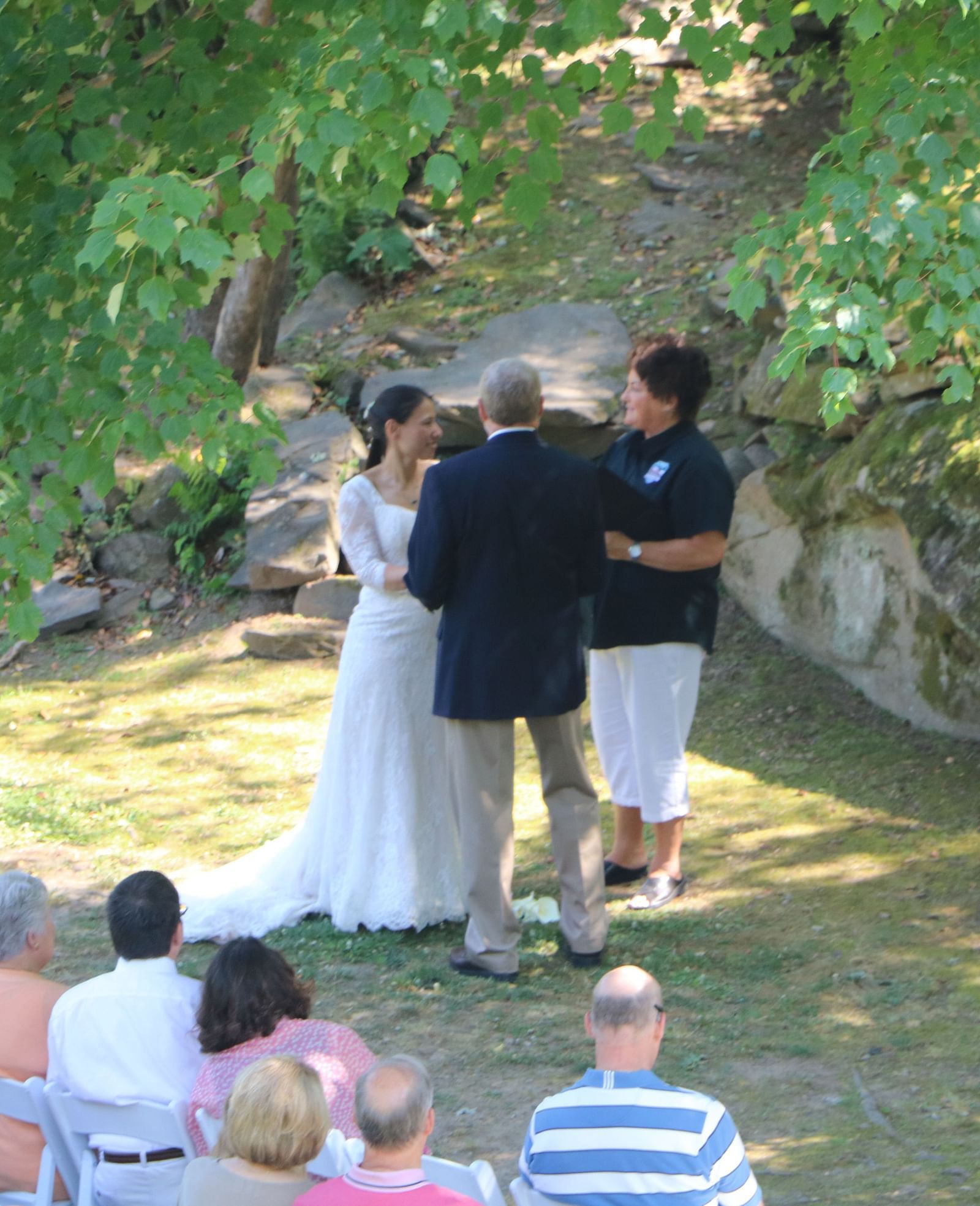 a couple getting married with the guests sitting in front of them witnessing the matrimony - Historic Tapoco Lodge