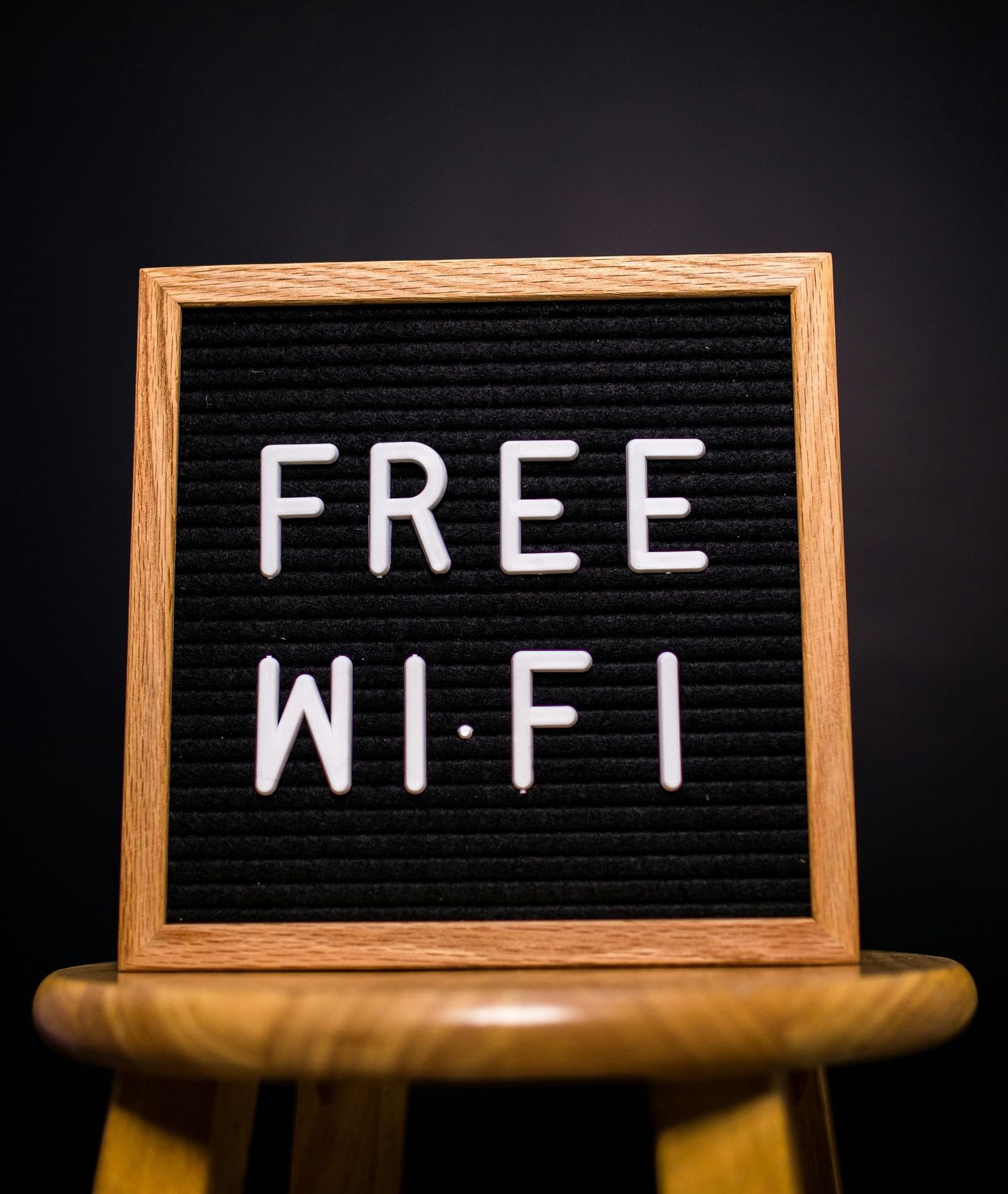 Free Wi-Fi written on a board that is kept on a stool.