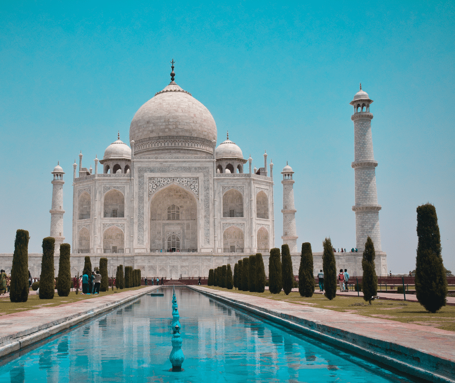 An image of Taj Mahal with the pool in front and bright sky