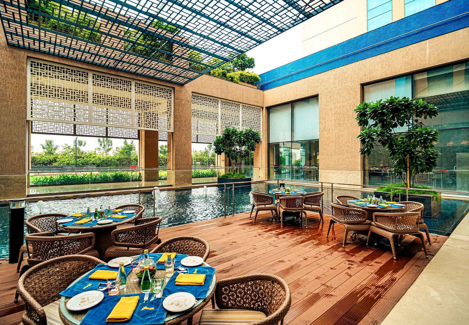 An outdoor dining setup next to a serene water feature, perfect for alfresco meals