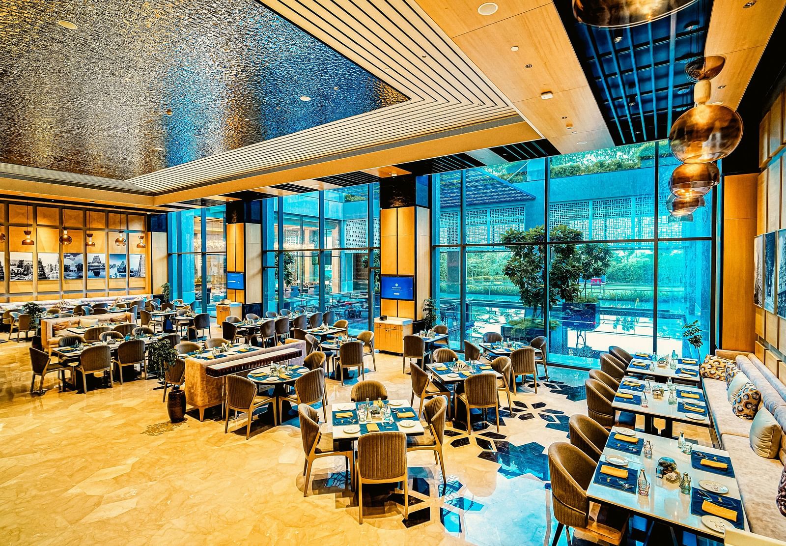 A bright and modern dining area with floor-to-ceiling windows, offering a relaxed and open atmosphere
