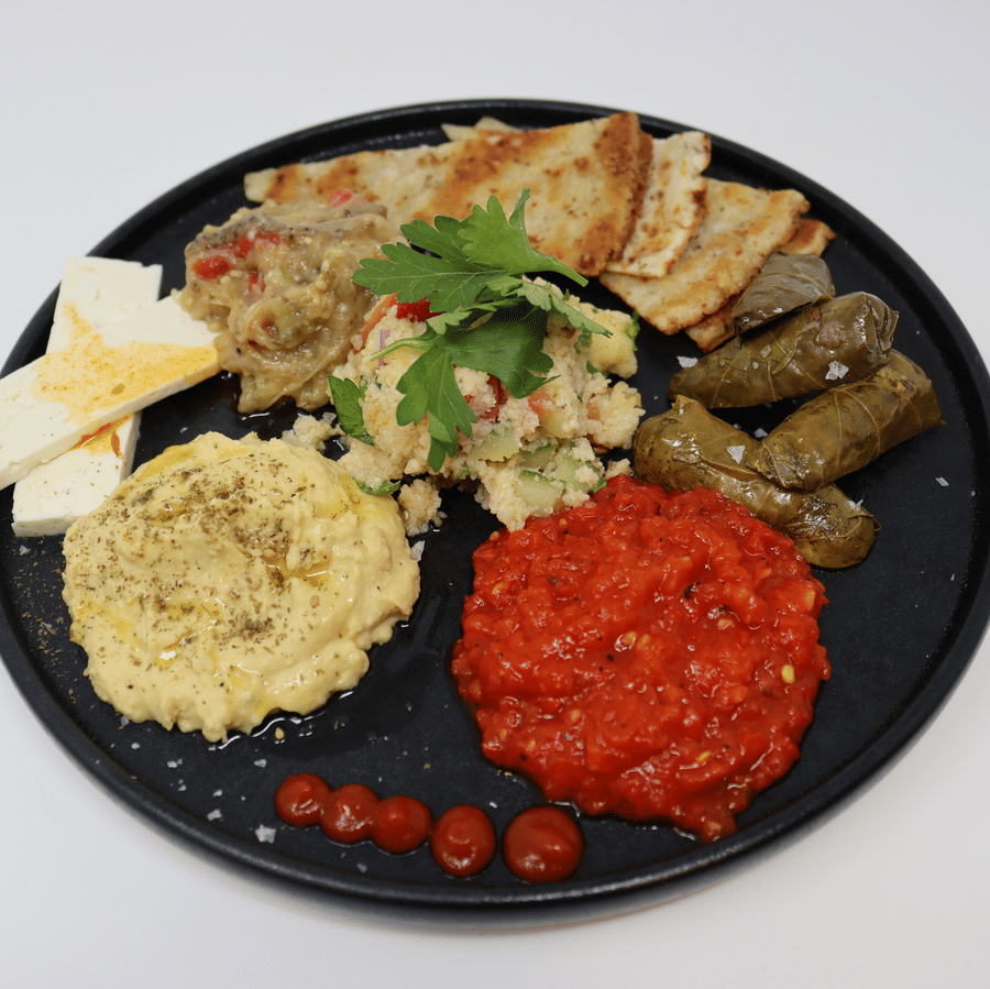Healthy food served on a round platter placed on a white surface at YO1 Longevity & Health Resorts, Catskills