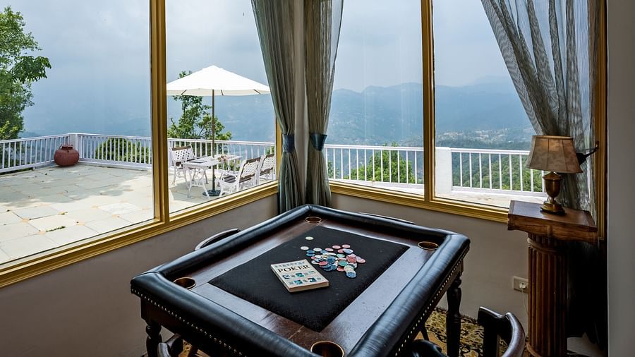 Side view of a room with large windows at Te Aroha By Shervani, Mukteshwar