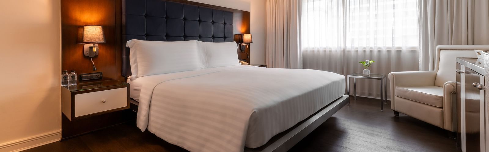 An overview of a double bed with side tables and lamps - Night Hotel Bangkok.