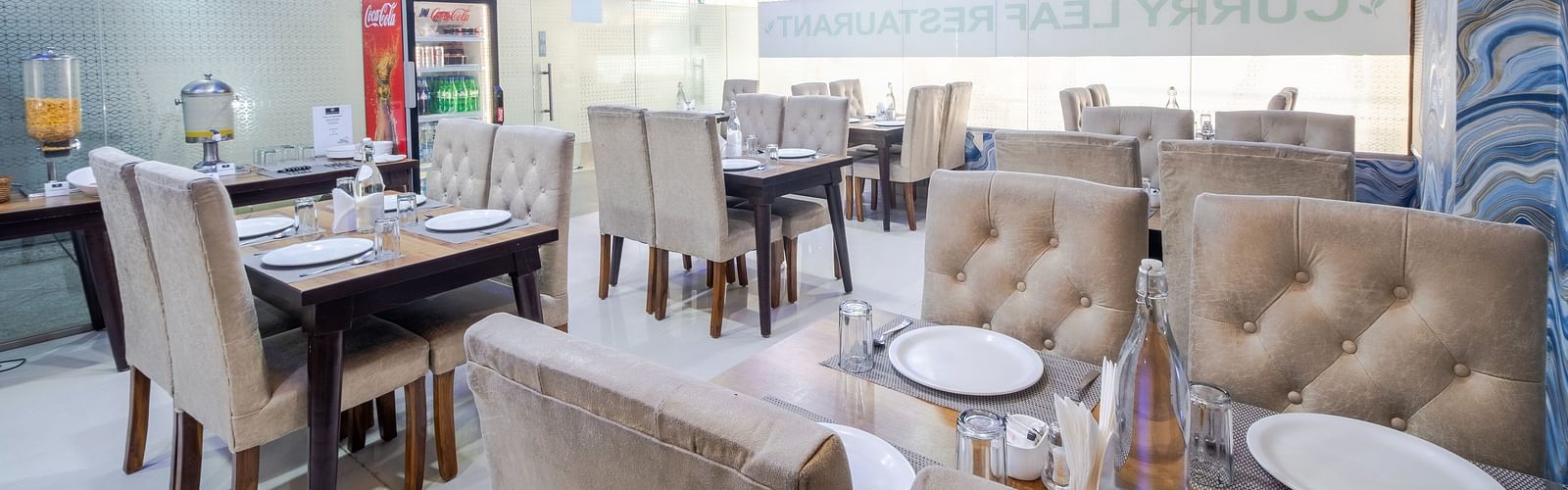 Dining tables arranged in the restaurant at Lemonridge Hotels