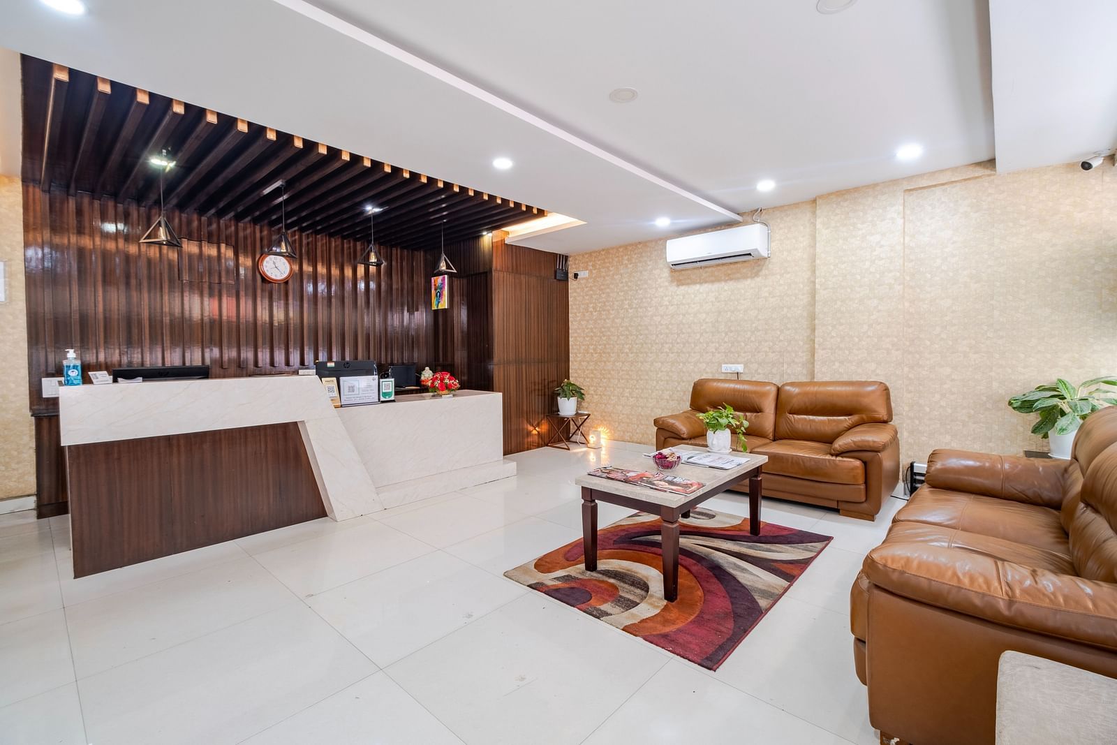 Reception view with sofa seating and AC unit at Lemonridge Hotels