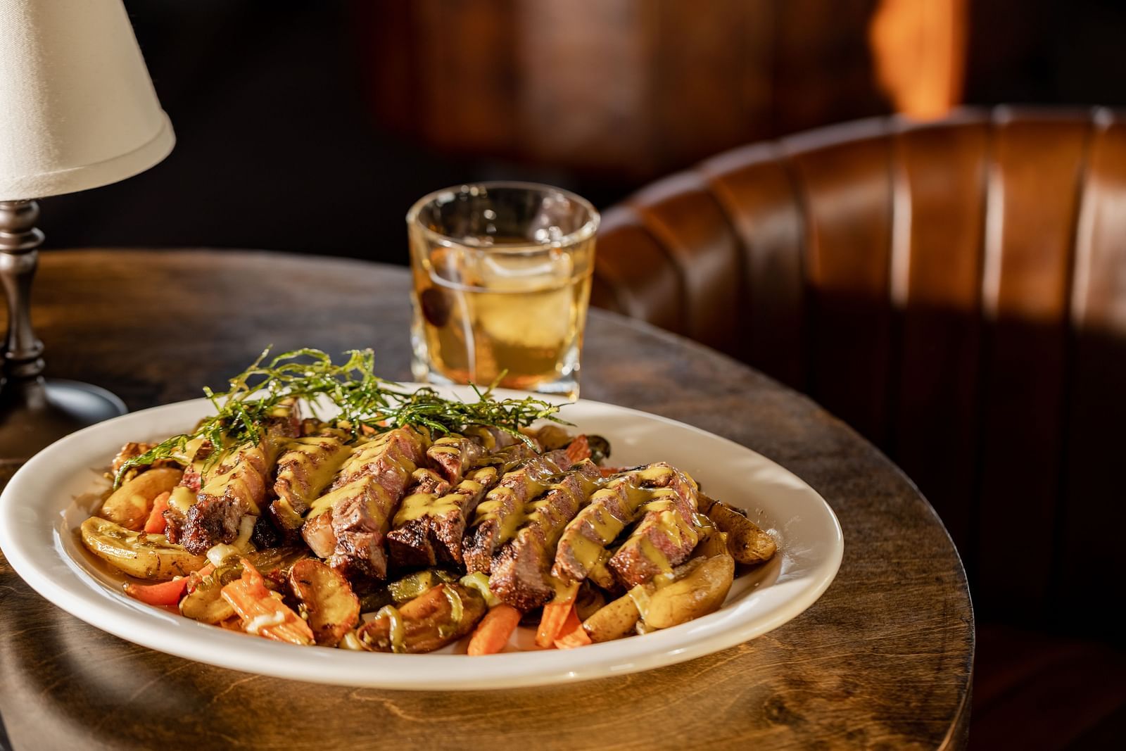 Close-up of a flavorful dish with seasoned meat and vegetables at The Grand Hotel & Ballroom, McKinney.