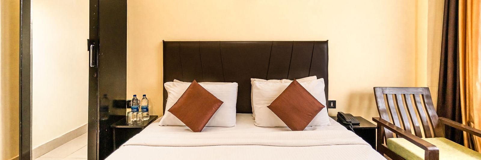 room at Flutter Hotels & Resorts featuring a bed and a wardrobe