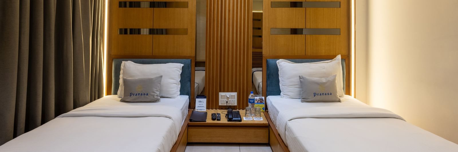 Twin beds highlighted with a central placement in the Superior Room of Pravasa Stay Vijay Nagar, Indore.