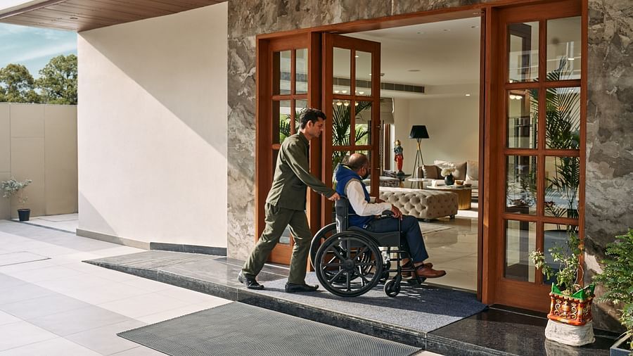 a differently abled guest being helped into the lobby of Triptam Hotel, Vrindavan