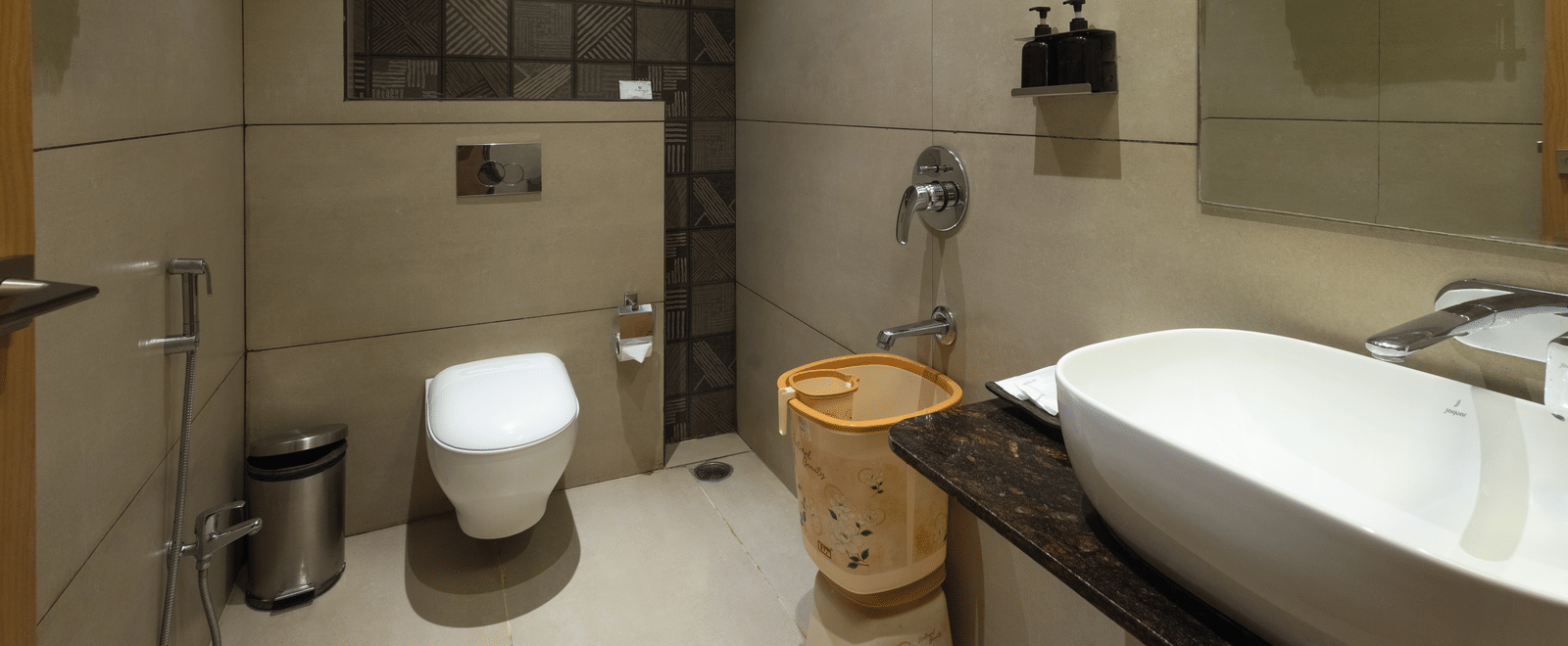 Interior of a bathroom with a toilet and a freestanding bath at Pravasa Stay Luv Kush, Indore.