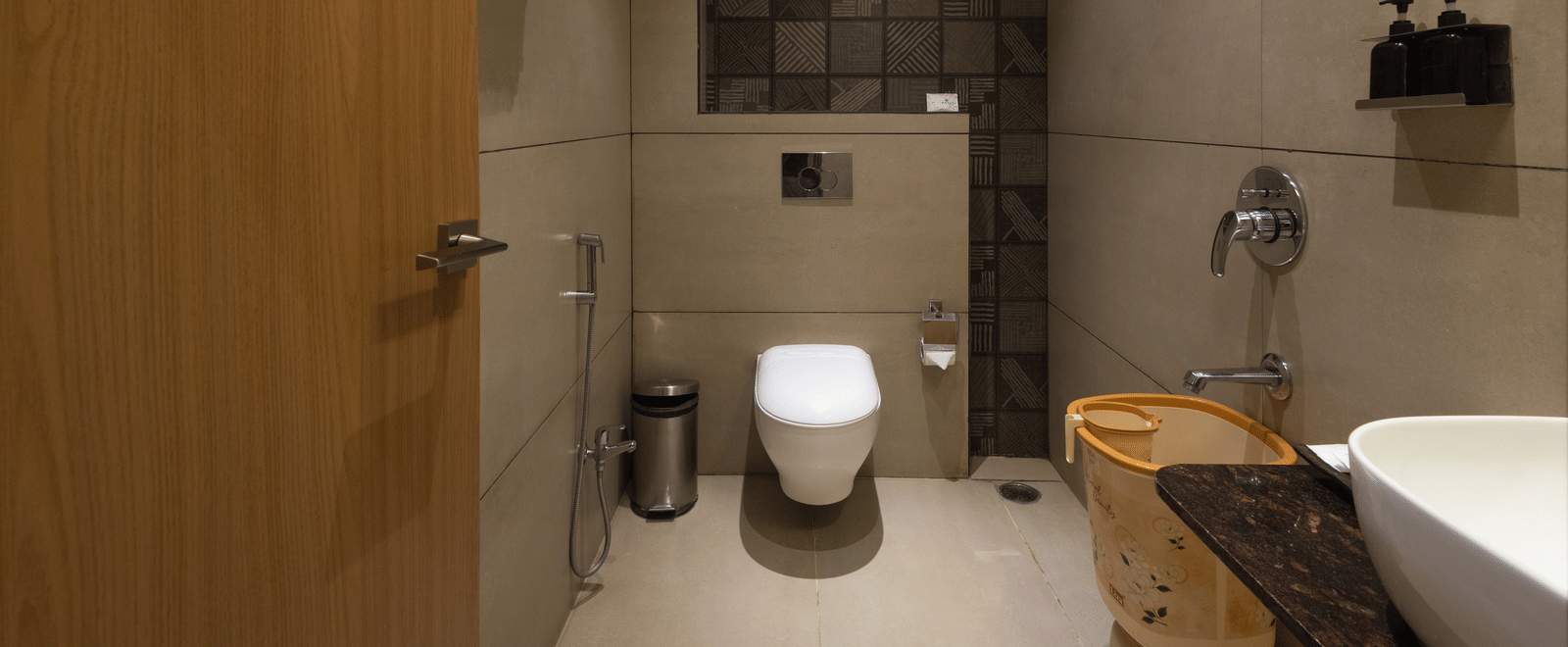 Interior of a bathroom with a toilet, shower area, and bath at Pravasa Stay Luv Kush, Indore.