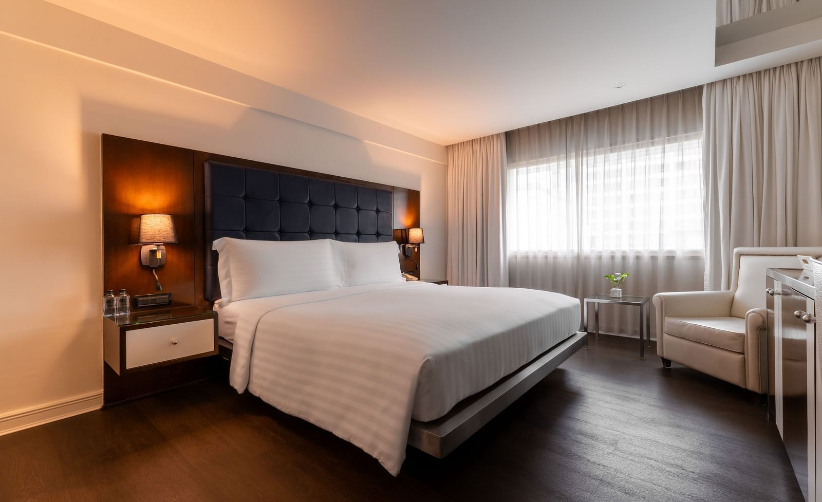 An overview of a double bed with side tables and lamps - Night Hotel Bangkok.