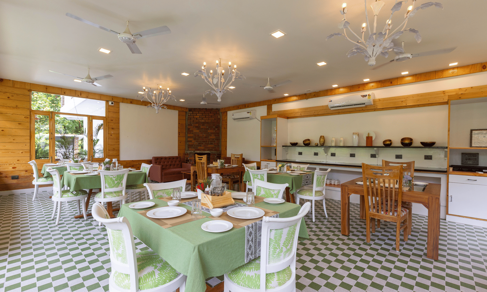 An elegant restaurant with neatly arranged tables and a warm, inviting ambience - Megha Resort & Villas, Dehradun