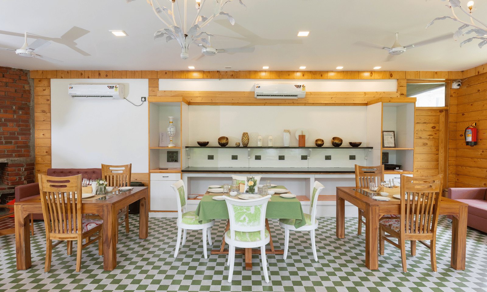 The interior of a dining hall with mixed wooden and green furniture and a patterned tiled floor - Megha Resort & Villas, Dehradun