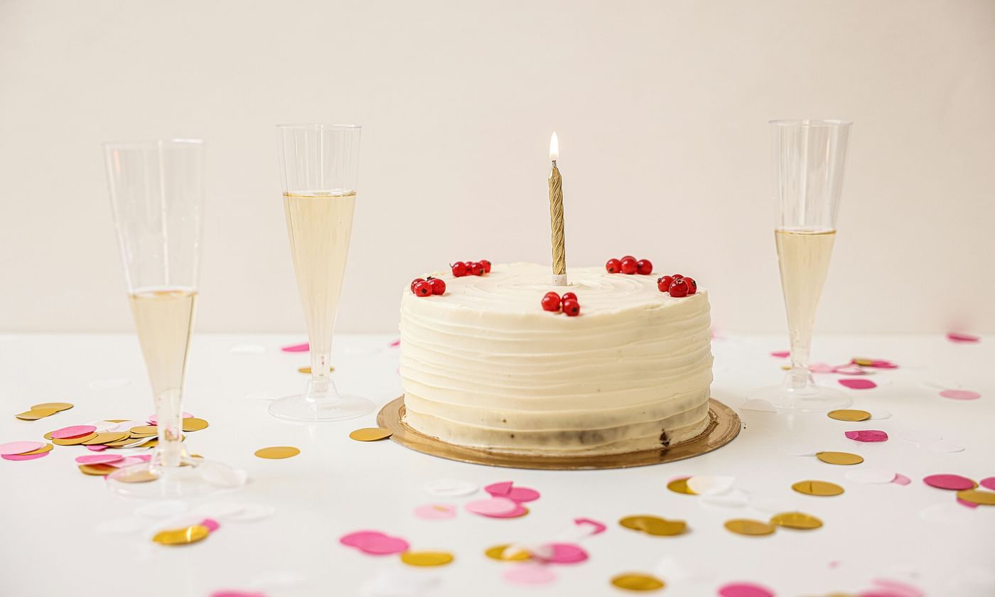Celebration setup with a white cake and decorative confetti