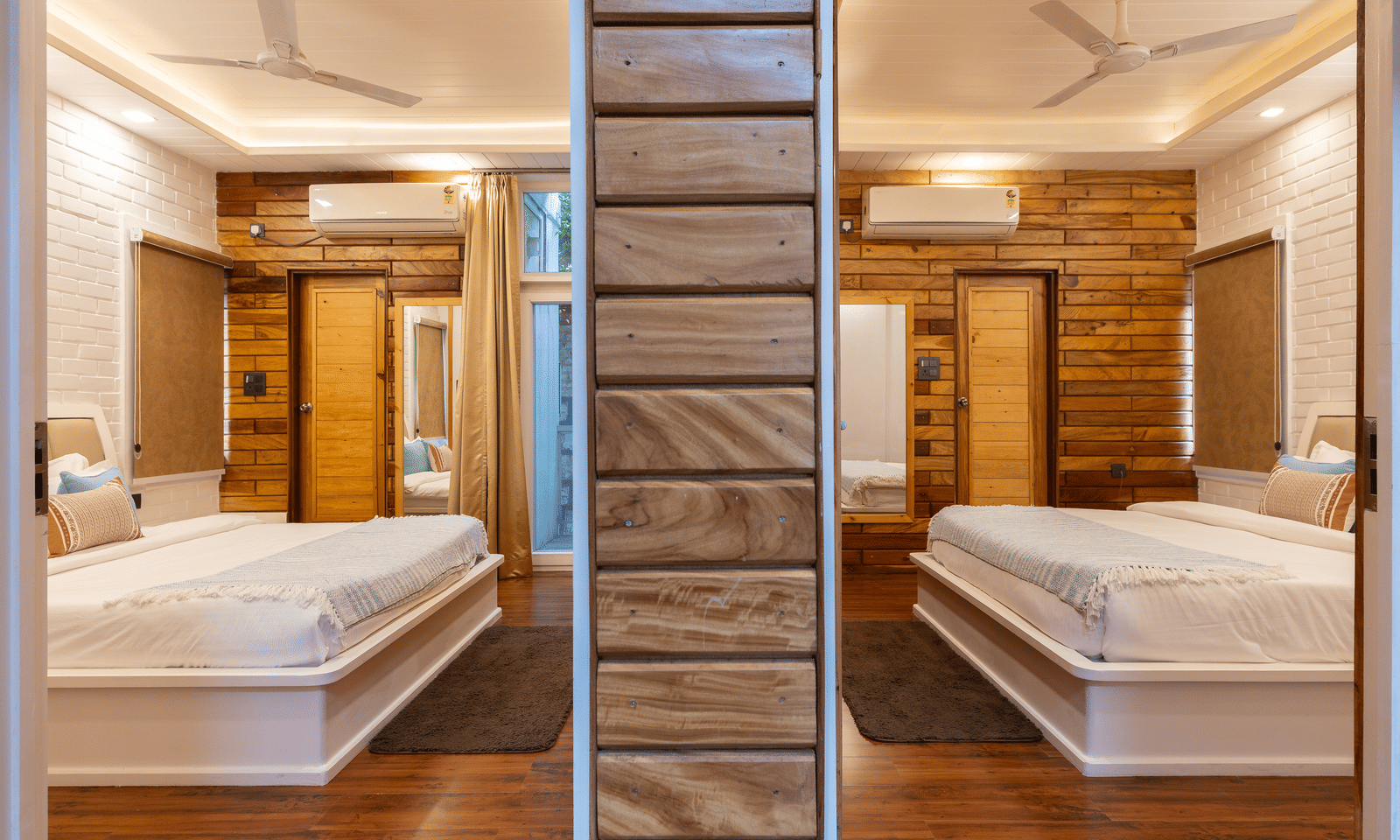 A bedroom at Megha Resort & Villas, Dehradun is shown with a mirrored wardrobe, reflecting the large, neatly made double bed.