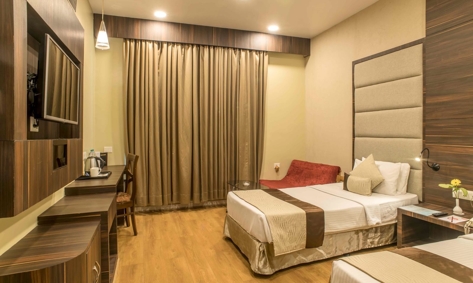 Hotel room with a double bed, a work desk, and neutral-toned furnishings | The Citi Residenci Hotel Durgapur