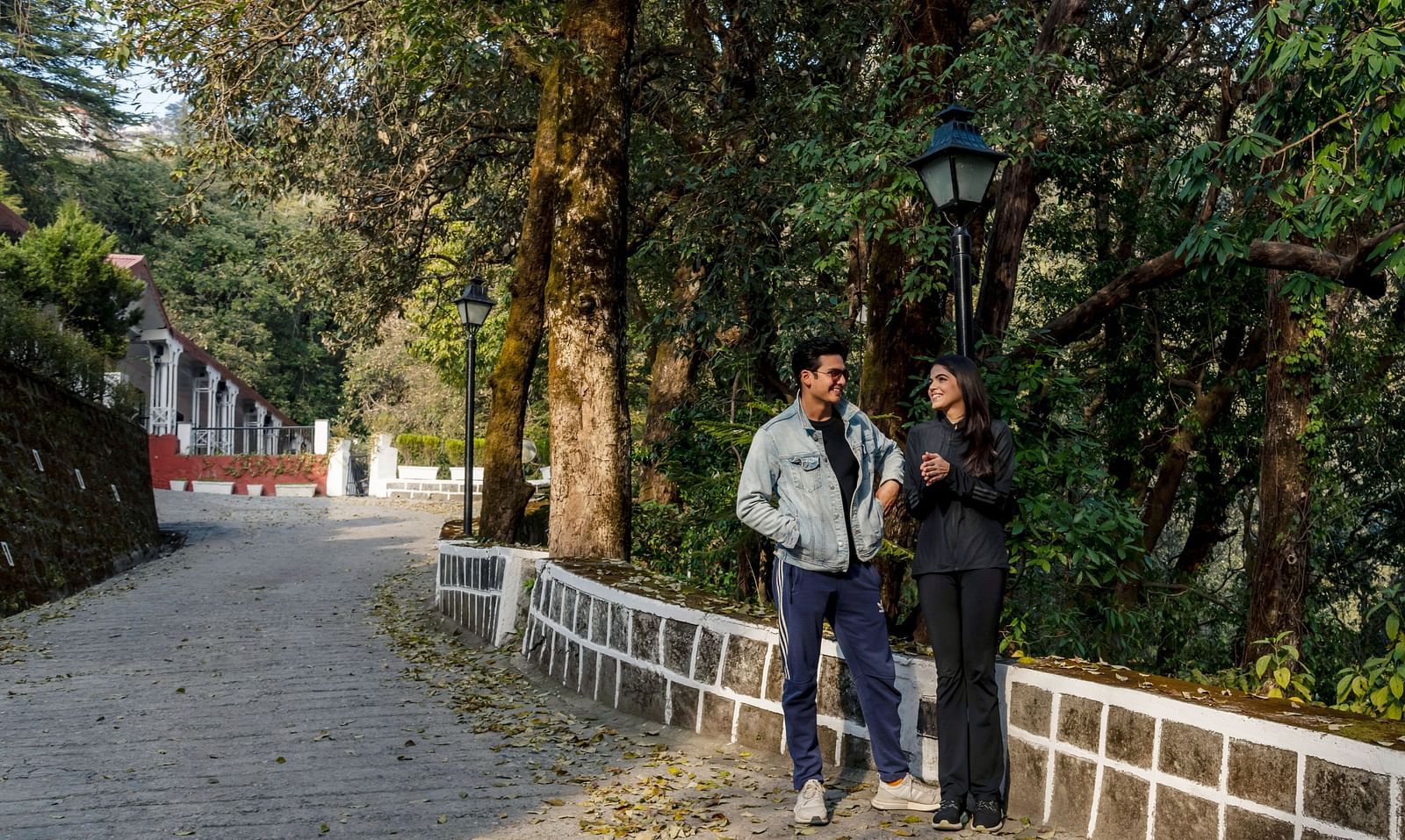 a couple having a conversation with a forest in the background