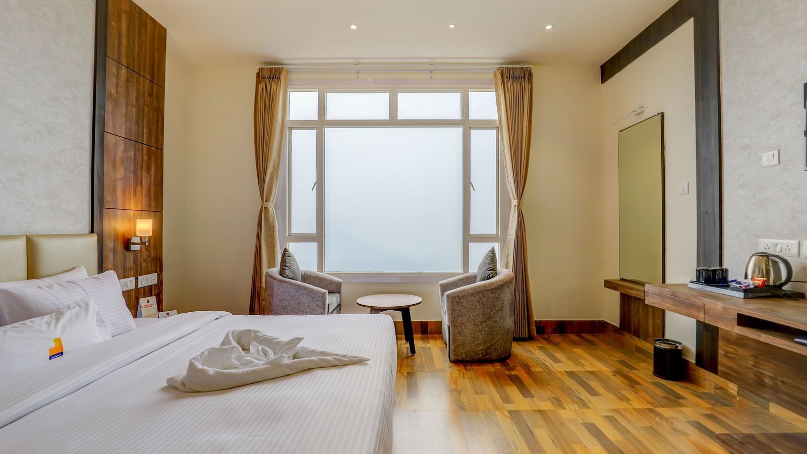 view of king size bed and TV of a Deluxe Room Banari Regency by Summit, Namchi