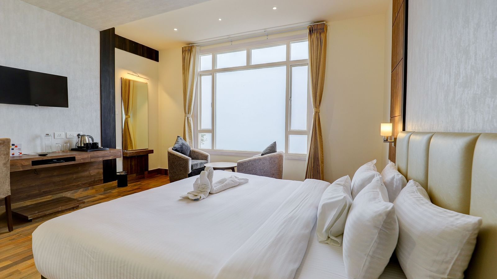 view of king size bed and TV of a Deluxe Room Banari Regency by Summit, Namchi