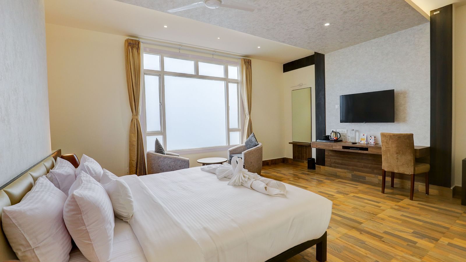 view of a king size bed of a Suite at Banari Regency by Summit, Namchi