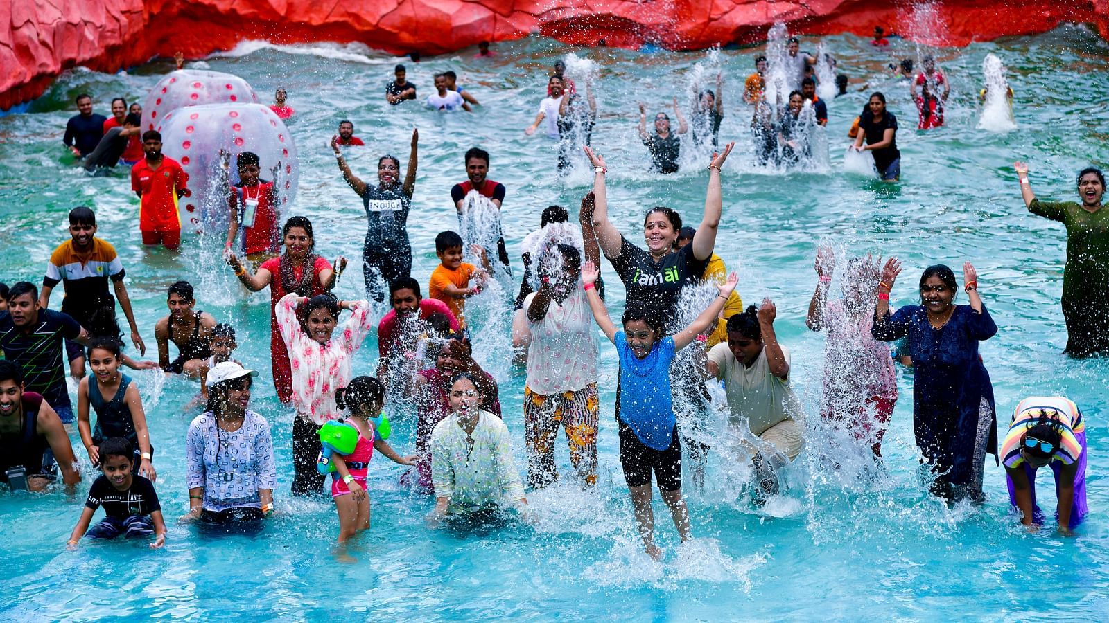 An overview of a wave pool inside Diamond Parks, Pune, with a group of people posing for a picture.