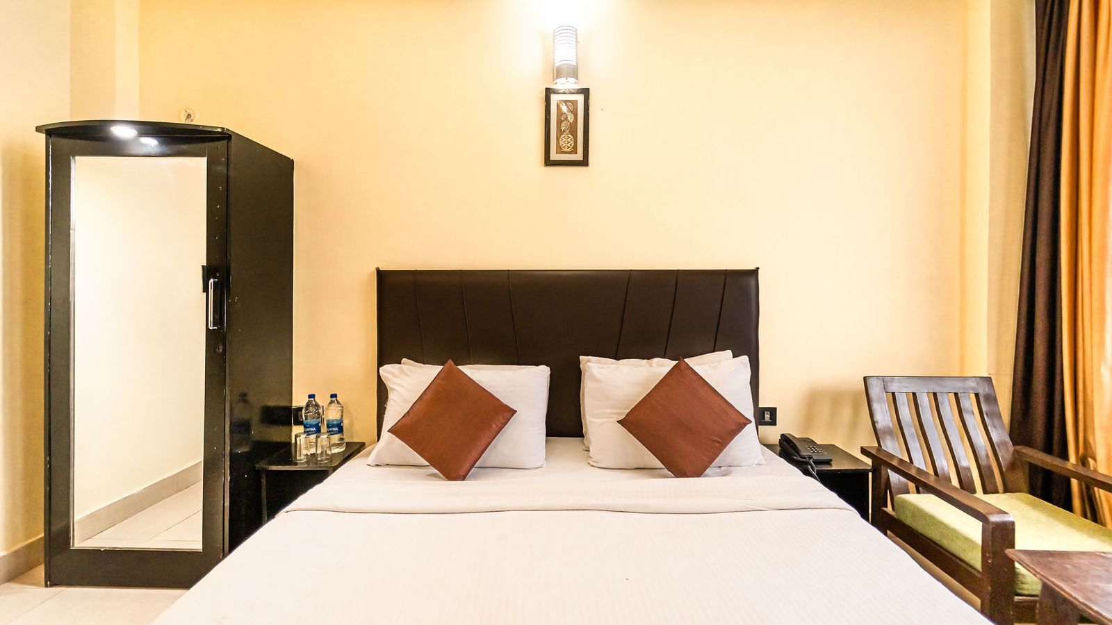 room at Flutter Hotels & Resorts featuring a bed and a wardrobe