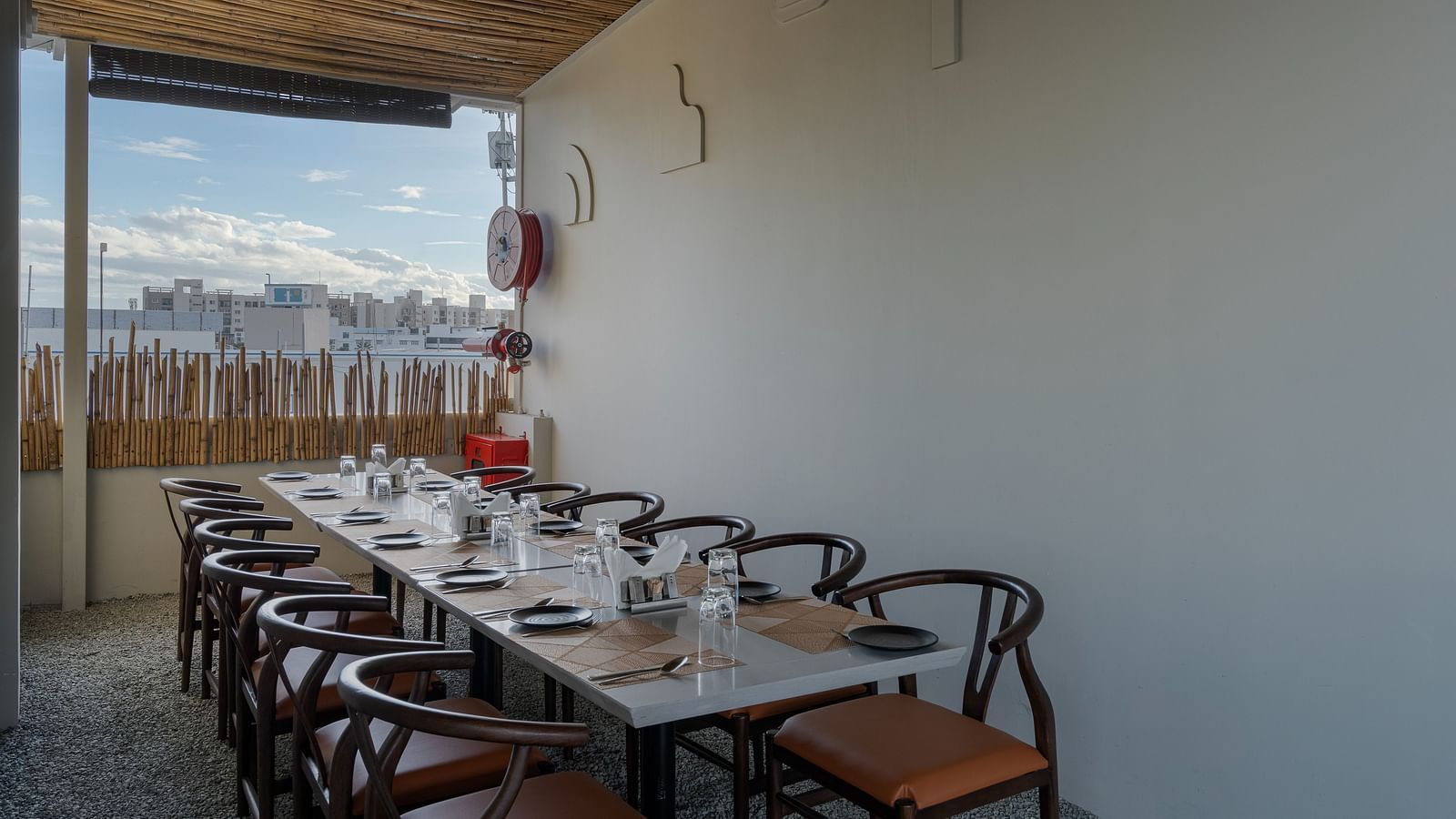 roof top diner with shades on the top to protect against sun and open sides for aerial views of the city.