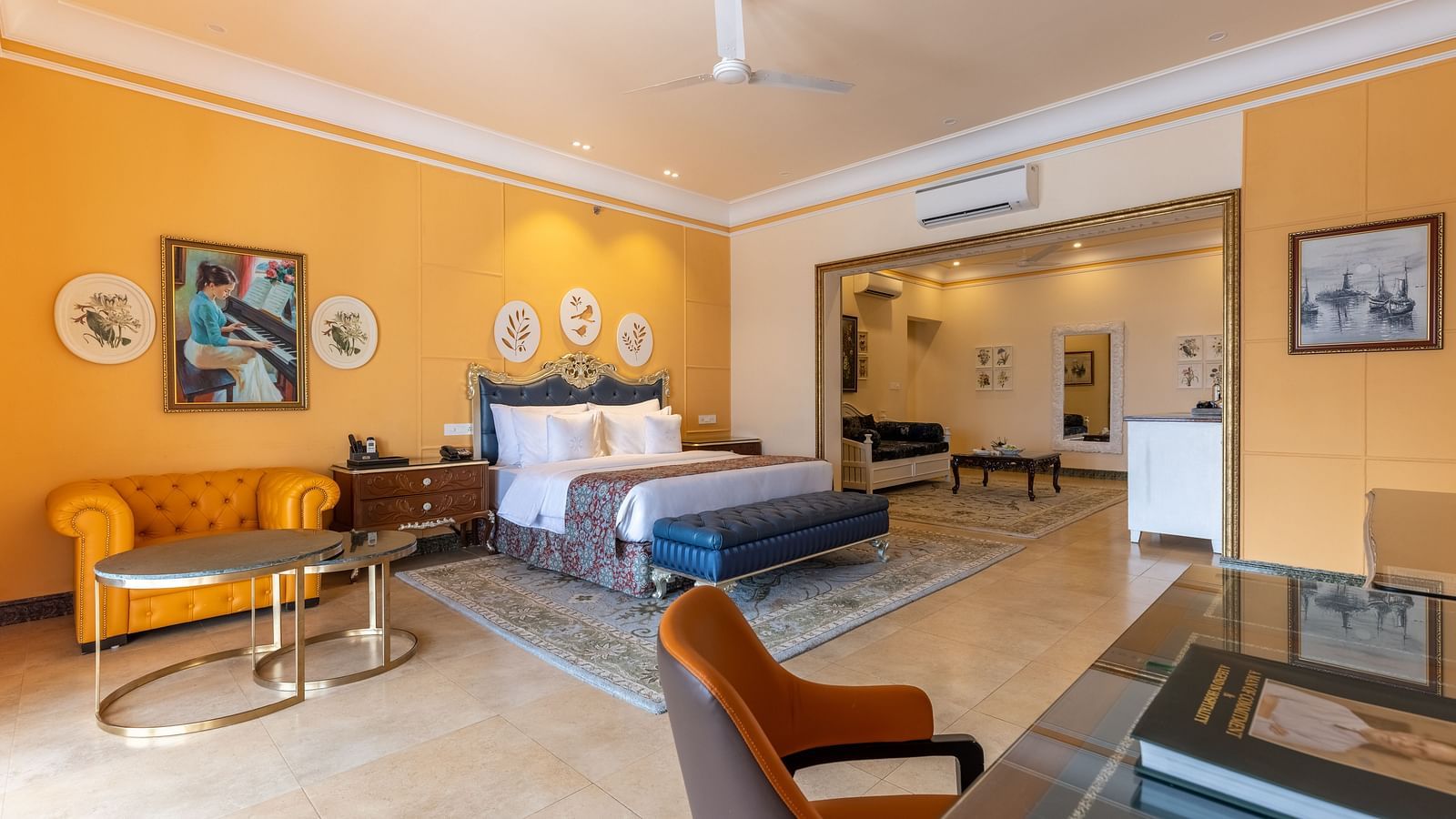 Spacious suite with orange accent wall and traditional decor at MAYFAIR Palm Beach Resort, Gopalpur-on-Sea