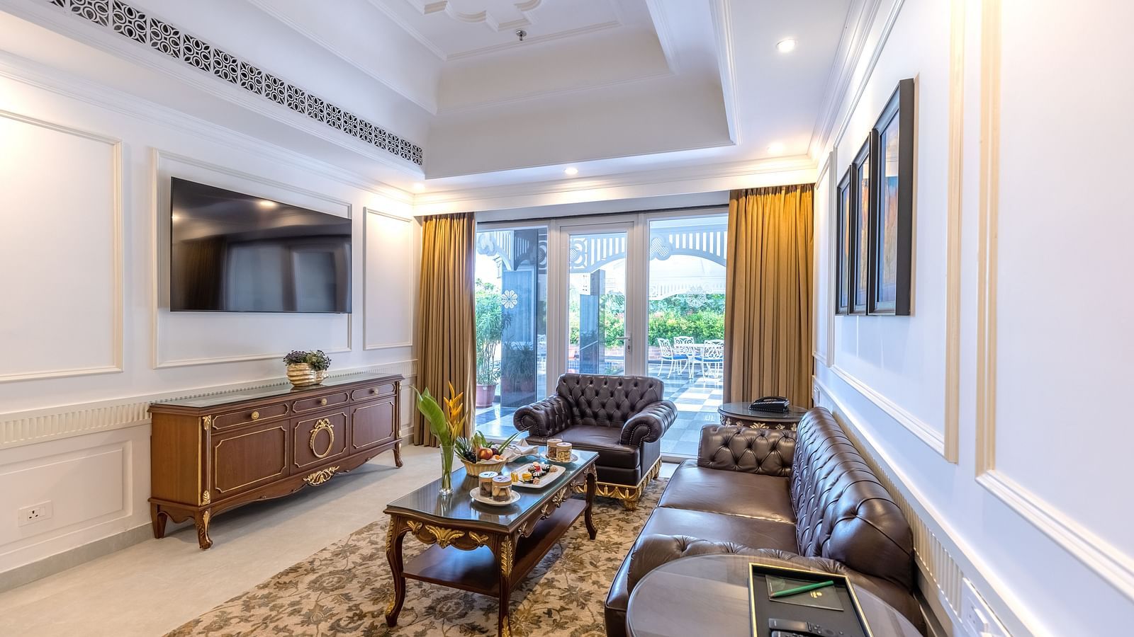 Stylish suite with blue accent wall, elegant seating area, and modern interiors at MAYFAIR Palm Beach Resort, Gopalpur-On-Sea.