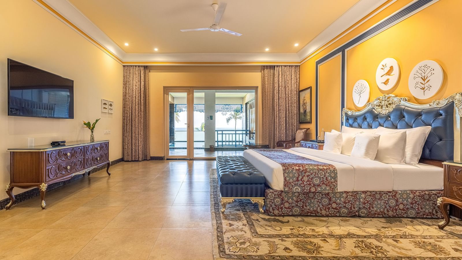 Duplicate of Spacious bedroom with wall-mounted TV, a workstation, and a seating area with large glass windows at MAYFAIR Palm Beach Resort, Gopalpur-On-Sea